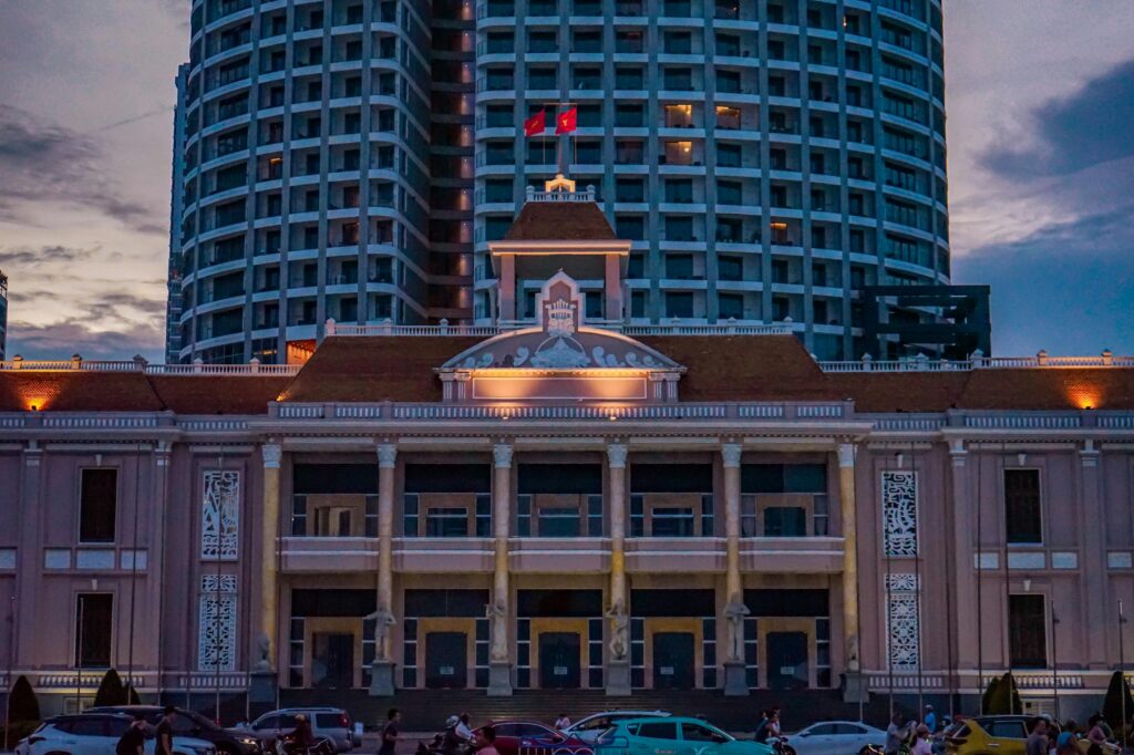 Illuminated Nha Trang Panorama Hotel against a dusk skyline in Vietnam.